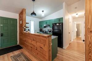 Open layout Kitchen and hallway to 2 main floor bedrooms and bathrooms