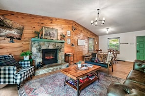 Our cozy cabin has an open concept kitchen, dining and living room.