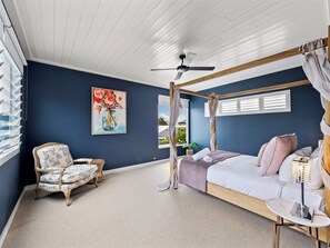 Indulge in the primary bedroom's dreamy canopy queen bed and cosy reading nook, with an ensuite featuring a freestanding bath and separate shower.