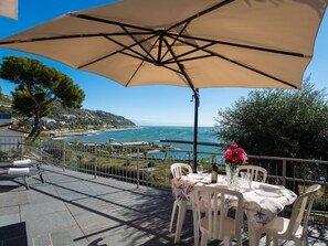 Umbrella, Property, Shade, Fashion Accessory, Vacation, Patio, Table, Furniture, Real Estate, Restaurant