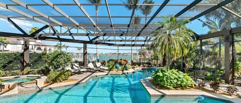 Behold the unparalleled beauty of Conover Court Villa’s resort-like pool and bay views during the day...