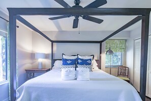 The master suite features a king bed with night stand and reading lamps.