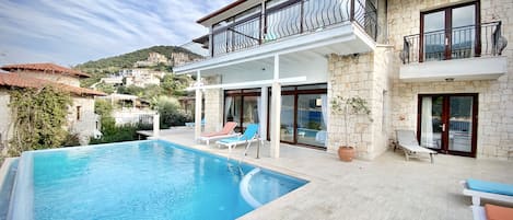 Exterior view of the villa with a private infinity pool.