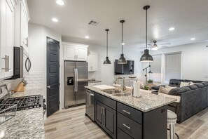 Kitchen View - The Kitchen is complete with everything you will need for meal preparations including pots, pans, baking dishes, plates, cups, silverware, cutlery, and an assortment of cooking utensils.