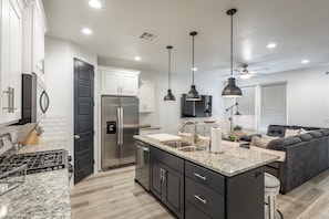 Kitchen View - The Kitchen is complete with everything you will need for meal preparations including pots, pans, baking dishes, plates, cups, silverware, cutlery, and an assortment of cooking utensils.