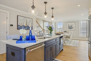 Luxury open concept kitchen and dining room with dishwasher and microwave in large island