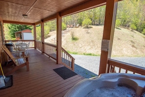 Relax and enjoy the covered porch in the hot tub...