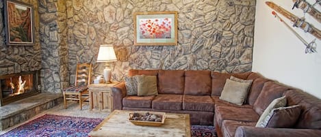 Stone accent wall and a warm gas fireplace