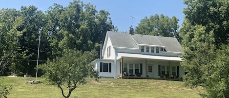 Quaint vintage farmhouse tucked into the hillside of 20 wooded acres 