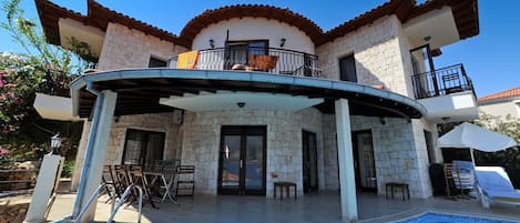 Exterior view of the villa with a private infinity pool.