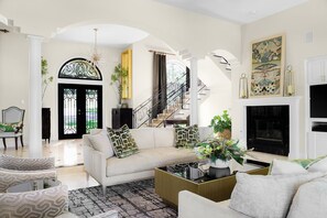 TWO 9' LUXURY SOFAS AND LUXURY CHAIRS GIVE SEATING FOR 10 IN THE LIVING ROOM