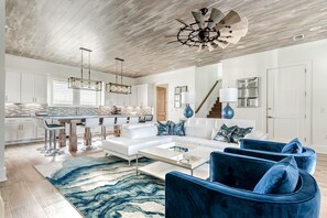 1st Floor -  A spacious open floor plan featuring a gourmet kitchen, living area, half bath, and laundry room a perfect gathering space.