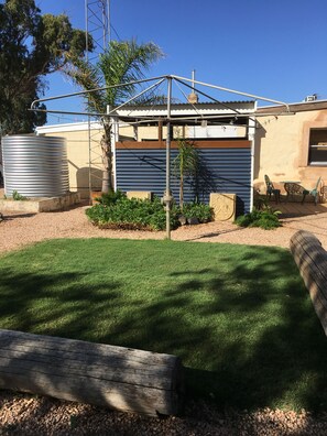 Small grass area and outdoor Shower and bath and new rain water tank. 