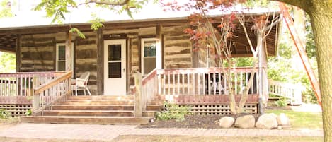 View of the front side of the log cabin. 