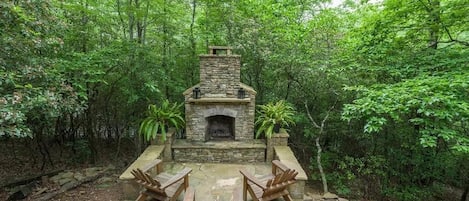 Outdoor stone wood burning fireplace.
