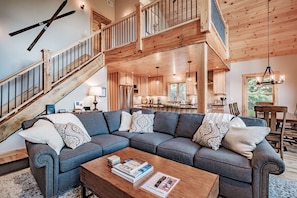 Another view of the great room showing loft sleeping area above.