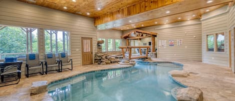 Luxurious pool room, heated pool and chairs for lounging!