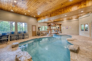 Luxurious pool room, heated pool and chairs for lounging!