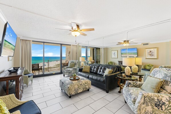 Beautiful Den space with leather sofa, ottoman, and twin recliners