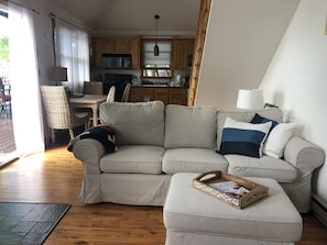 Living room view to dining and kitchen areas. The hardwood floors are stunning