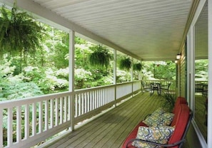 Front porch offers a great place to read and relax; surrounded by Leelanau forests.