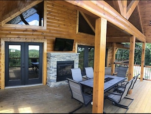 Upper deck with double sided fireplace, tv and gas grill (not pictured).