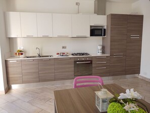 Cabinetry, Countertop, Furniture, Property, Kitchen Stove, Kitchen Appliance, Kitchen, Table, Wood, Interior Design