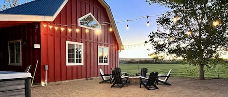 The red barn, fireplace and hot tub to the left. 