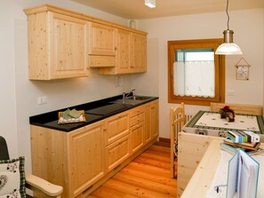 Countertop, Cabinetry, Property, Furniture, Sink, Kitchen, Drawer, Wood, Lighting, Interior Design