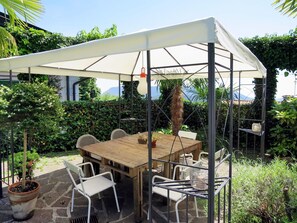 Plant, Property, Sky, Table, Furniture, Outdoor Table, Shade, Chair, Building, Outdoor Furniture