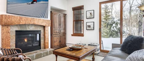 Relax in his spacious living room featuring a  fireplace with gas logs.