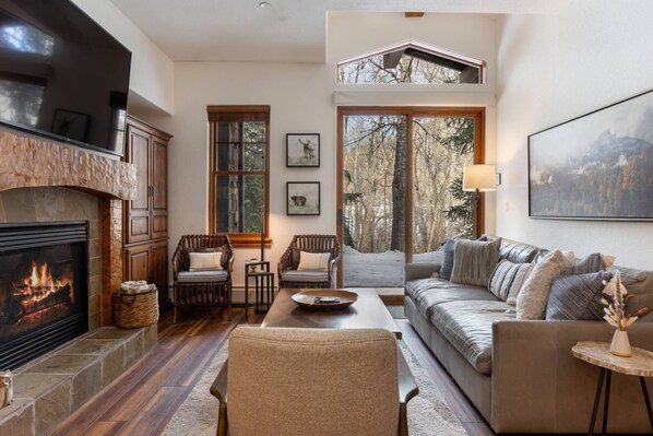 Relax in his spacious living room featuring a  fireplace with gas logs.