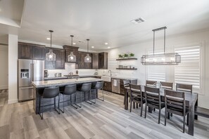 Kitchen View - The kitchen is fully stocked with all the dishes, cookware, baking pans, and cutlery you will need for meal preparations and includes stainless steel appliances and granite counter tops.