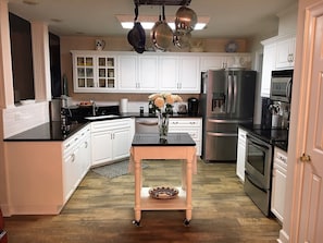 Black and white fully furnished kitchen just off the great room.