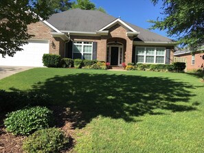 Front of the home showing mature landscaping.