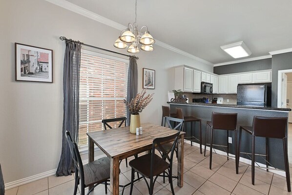 This dining area offers seating for 4 at the dining room table along with 4 barstools for added seating