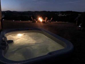 The private hot tub overlooks the fire pit, and the majestic Hill Country mountains beyond.