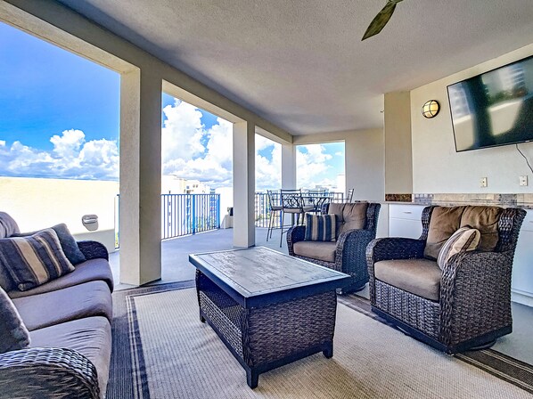 A sofa and two rocking chairs in the outdoor living area
