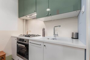 Independent kitchen with a kettle, fridge freezer, dishwasher, gas hob and oven.
