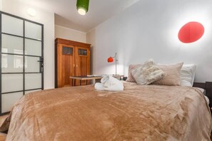 Stylish bedroom with a double bed, bedside table and wardrobe.
