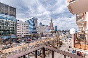 The view from the balcony overlooks the street and the city.