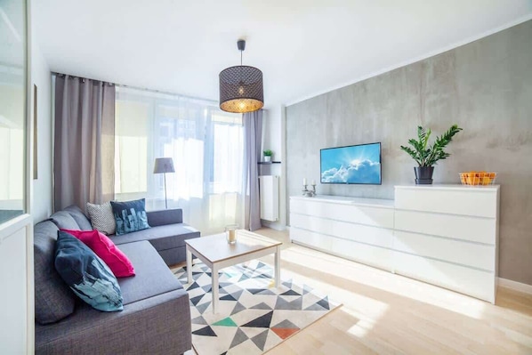 Relax in the stylish living room with a comfortable sofa and modern decor.