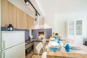 The living area features a sleek coffee table and a flat-screen television.