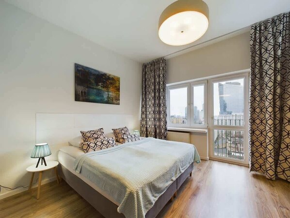 Living area with a comfortable sofa bed, two single beds joined to a double bed, Smart TV, desk with a chair and closet