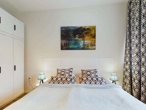 Two single beds joined to a double bed in the studio