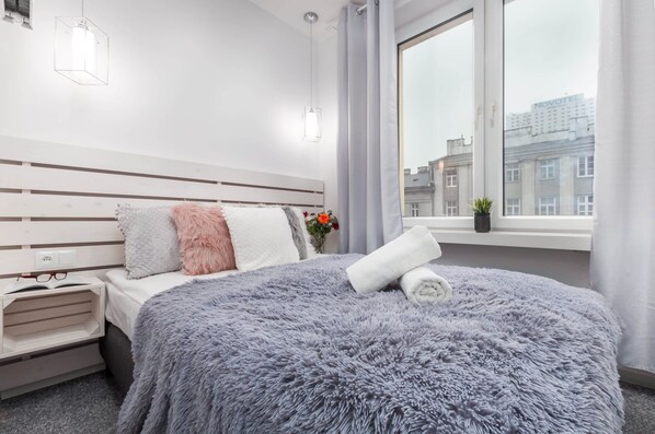 Comfortable bedroom with a double bed and wardrobe.