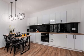Fully equipped kitchenette with a kettle, fridge freezer, induction hob, oven, a microwave oven and toaster.