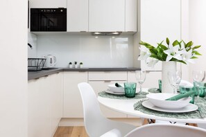 The sleek design of the kitchenette blending seamlessly with the living area.