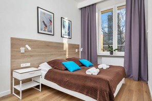 The cosy bedroom features a luxurious double bed and ample storage.