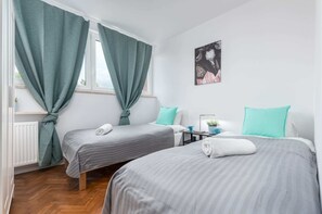 Bedroom with comfortable 2 single beds and wardrobe.